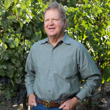 Older white gentleman standing in the vineyard