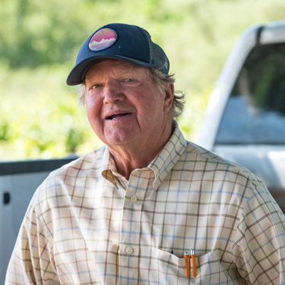 A man in a checkered shirt with a hat on