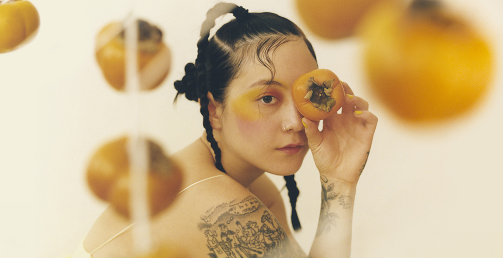 Woman holding a persimmon