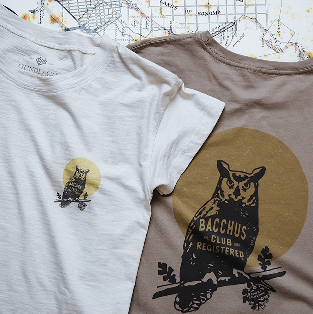 White shirt with an owl printed on the chest and brown shirt with an owl printed on the back
