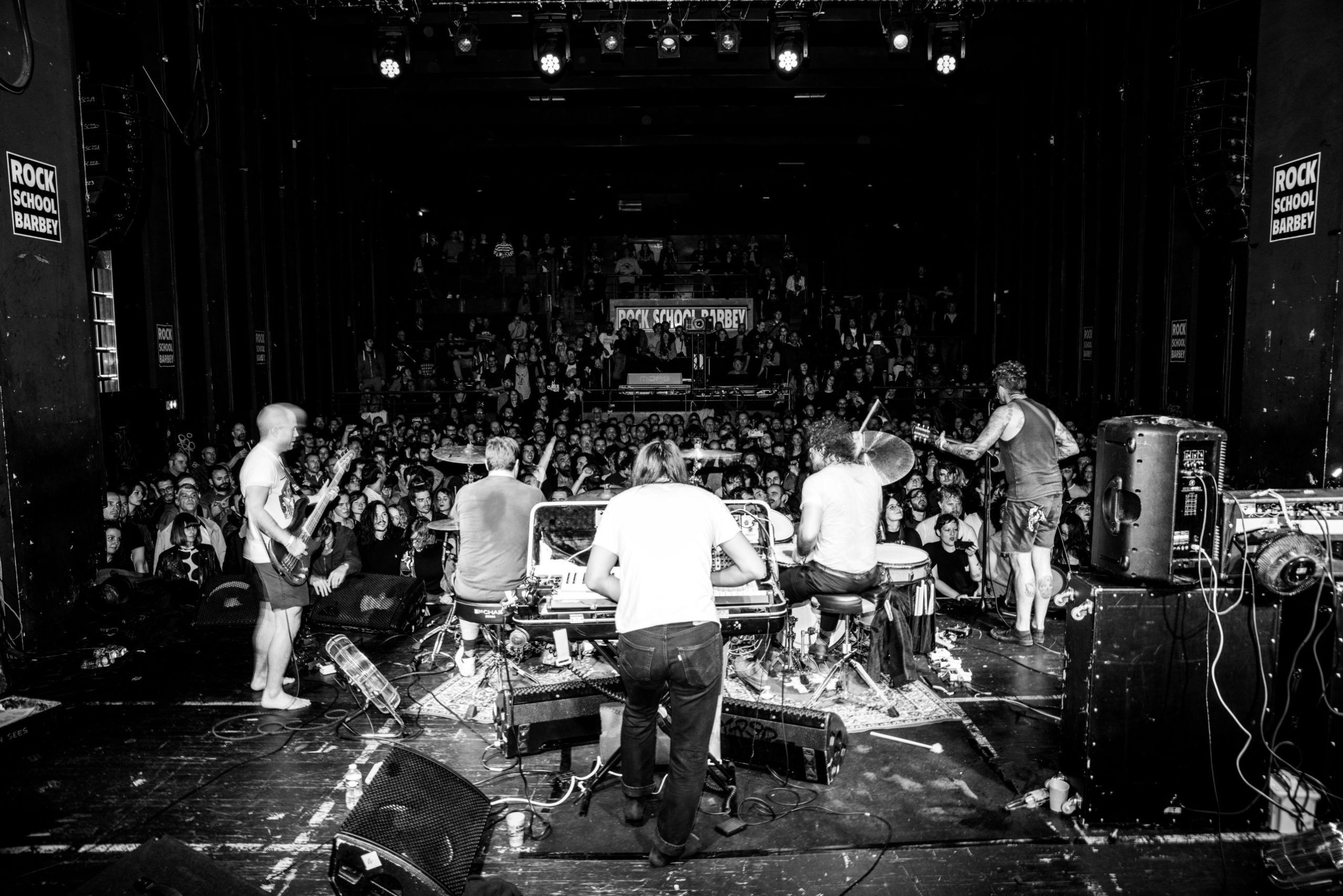 Black and white photo of a music band in front of the public